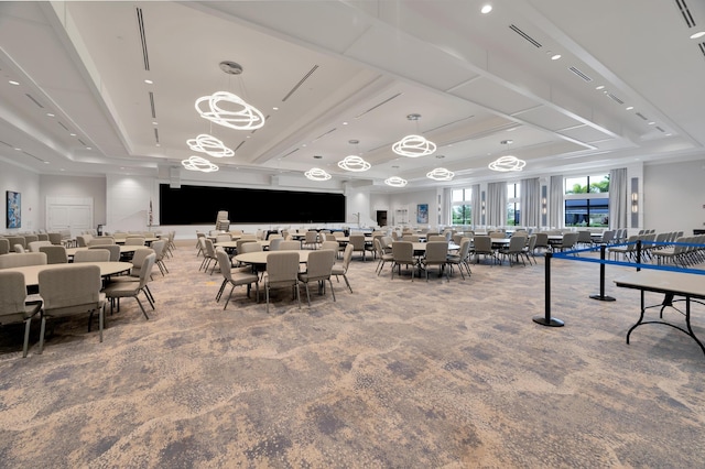 dining space with a raised ceiling and carpet