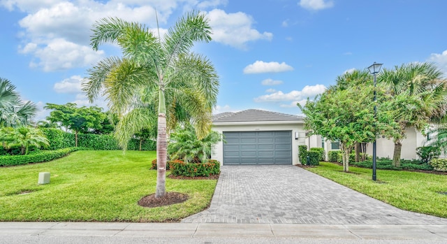 view of front of property with a garage and a front lawn