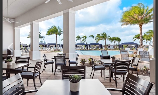 view of patio featuring a community pool and ceiling fan