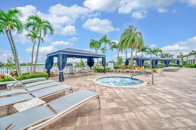 view of pool featuring a community hot tub, a gazebo, and a patio