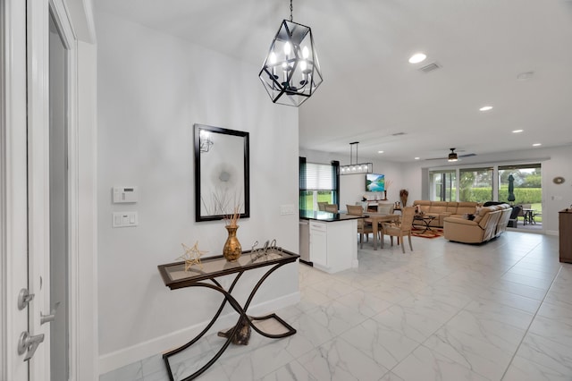 hallway featuring an inviting chandelier