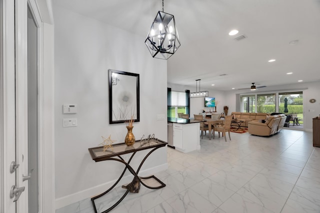 hallway with a chandelier