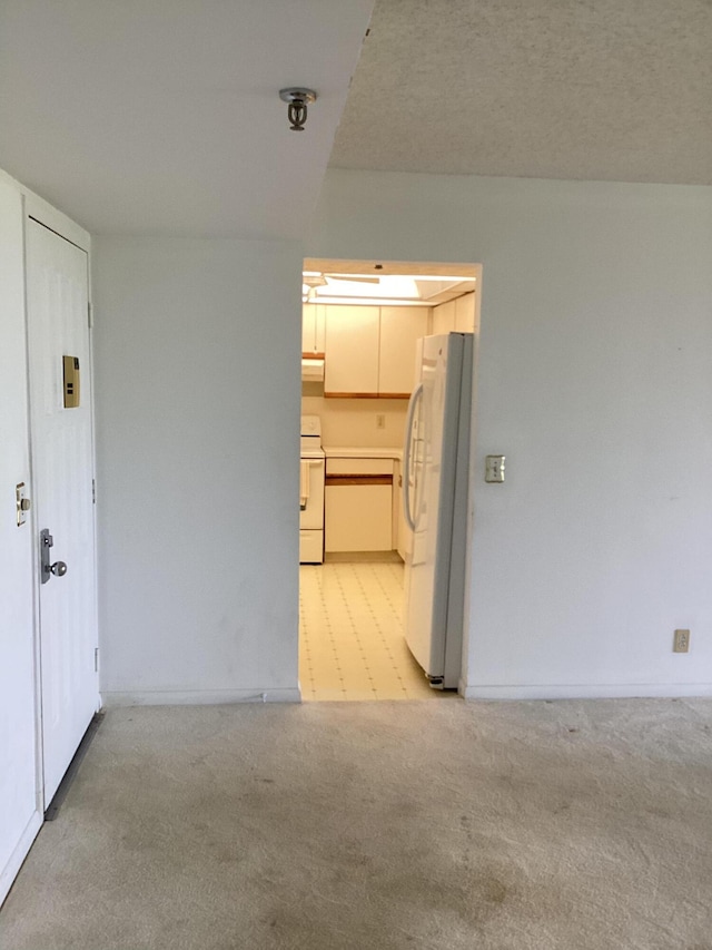 carpeted spare room with a textured ceiling