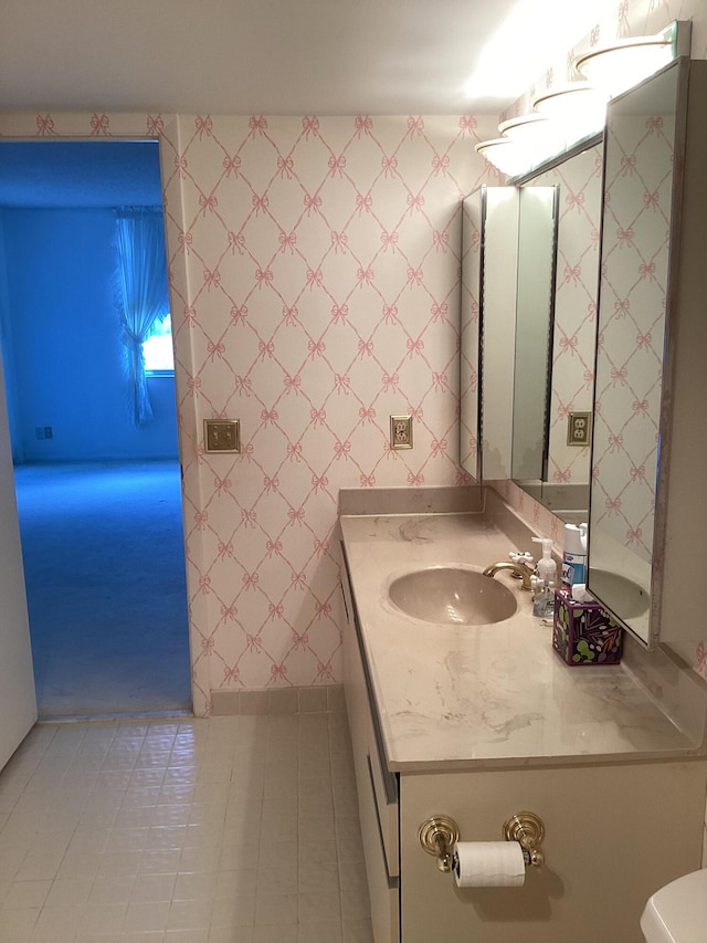 bathroom with vanity, toilet, and tile patterned floors