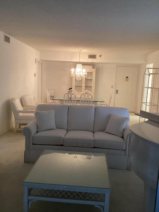 living room featuring a notable chandelier and carpet flooring