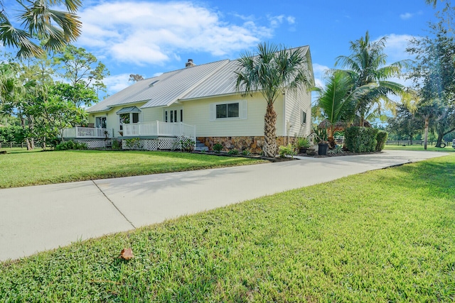 view of property exterior with a deck and a yard