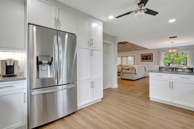 kitchen with light wood-type flooring, white cabinetry, ceiling fan, and stainless steel fridge with ice dispenser