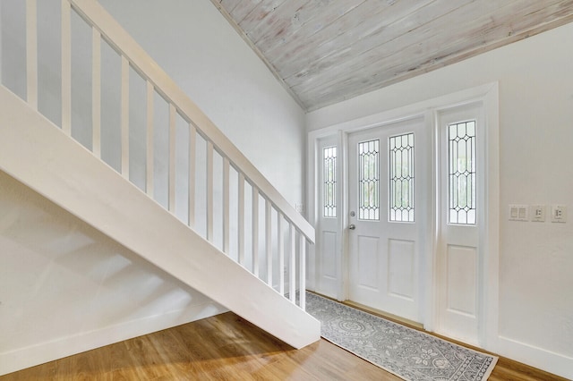 foyer with wood-type flooring, wood ceiling, and vaulted ceiling