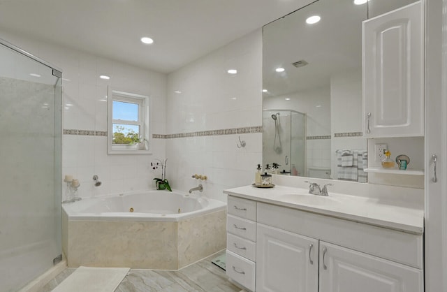 bathroom with vanity and separate shower and tub