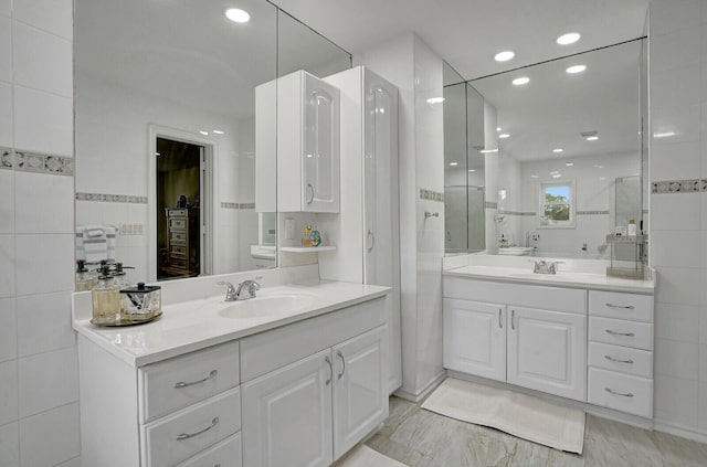 bathroom featuring a shower and vanity