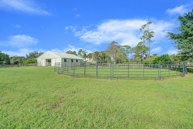 view of yard featuring a rural view and an outdoor structure