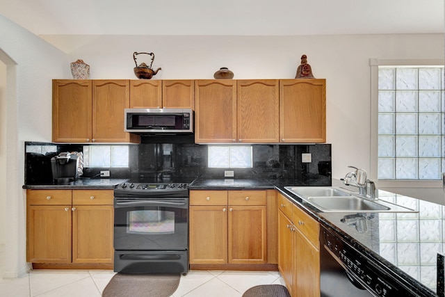 kitchen with tasteful backsplash, appliances with stainless steel finishes, sink, and light tile patterned flooring