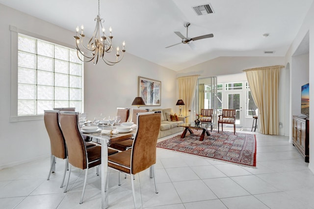 tiled dining area with ceiling fan with notable chandelier, vaulted ceiling, and a wealth of natural light