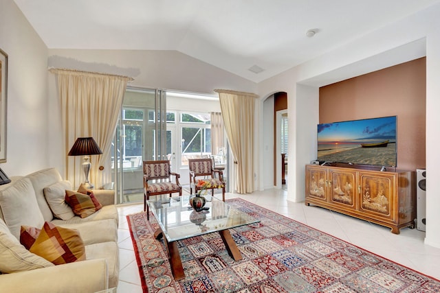 tiled living room featuring lofted ceiling