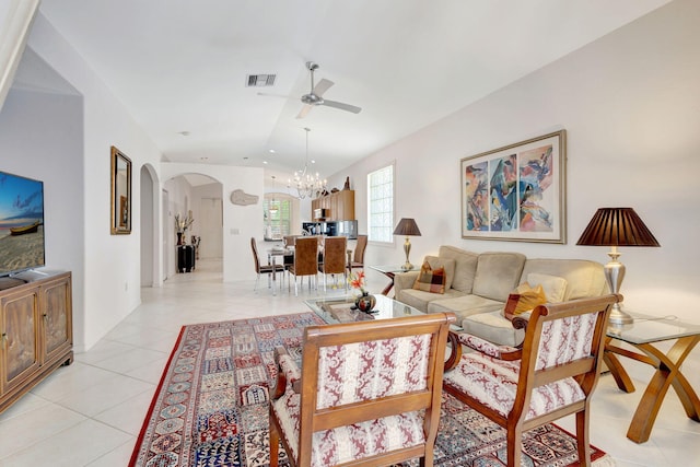 living room with ceiling fan with notable chandelier and light tile patterned floors