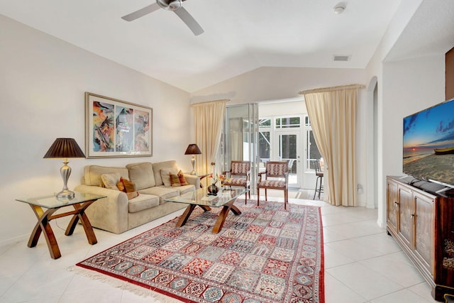 living room featuring vaulted ceiling, light tile patterned floors, and ceiling fan