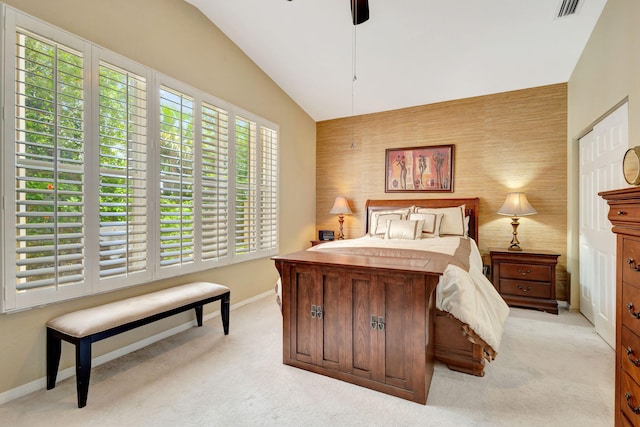 carpeted bedroom with vaulted ceiling, multiple windows, and ceiling fan