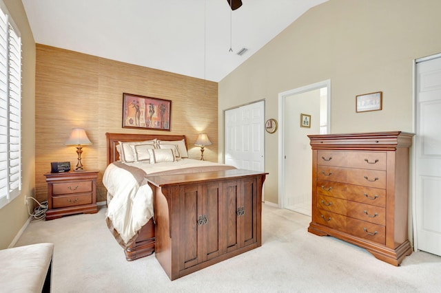 carpeted bedroom with multiple windows, high vaulted ceiling, and ceiling fan