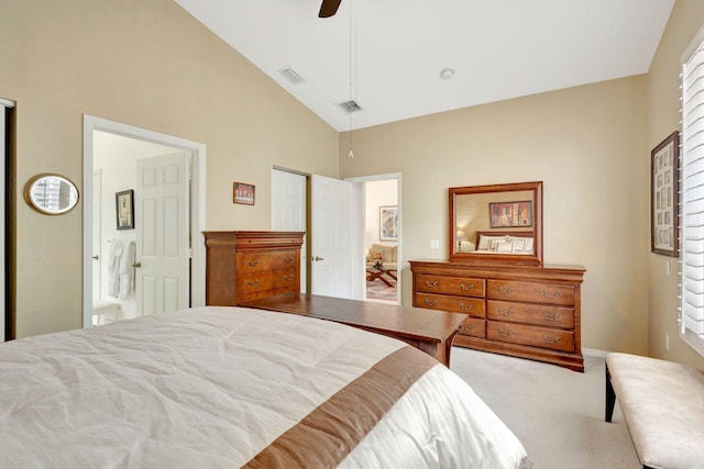 bedroom featuring a closet, light carpet, ensuite bathroom, high vaulted ceiling, and ceiling fan