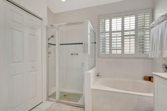 bathroom featuring vanity, separate shower and tub, and tile patterned flooring