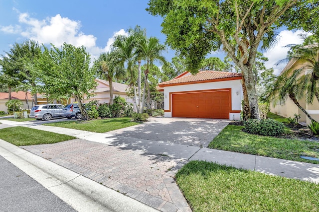 view of front of home featuring a front lawn and a garage