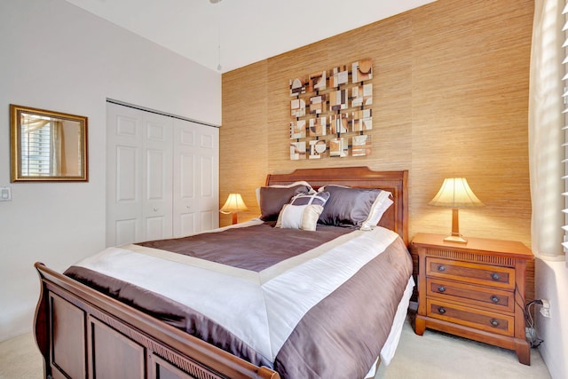 bedroom featuring a closet and light carpet