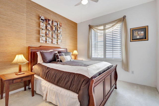 bedroom with ceiling fan and light carpet