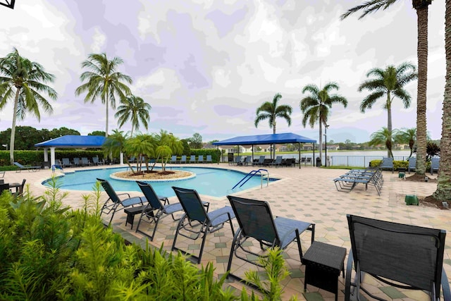 view of pool with a patio, a gazebo, and a water view