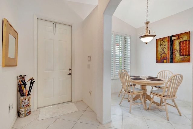 tiled foyer featuring lofted ceiling