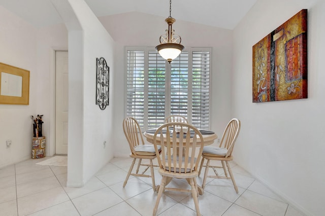 tiled dining area with vaulted ceiling