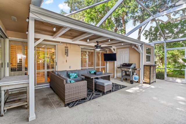 exterior space featuring grilling area, glass enclosure, an outdoor hangout area, and ceiling fan