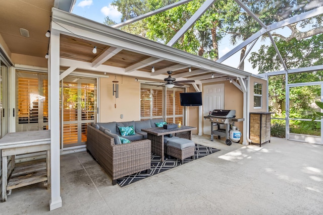 view of patio featuring a lanai, ceiling fan, a grill, and an outdoor hangout area