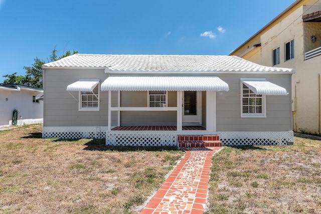 view of front of home featuring covered porch and a front yard