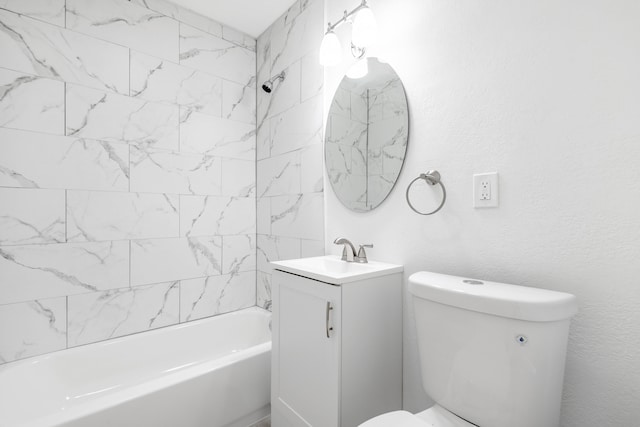 full bathroom featuring tiled shower / bath combo, toilet, and vanity