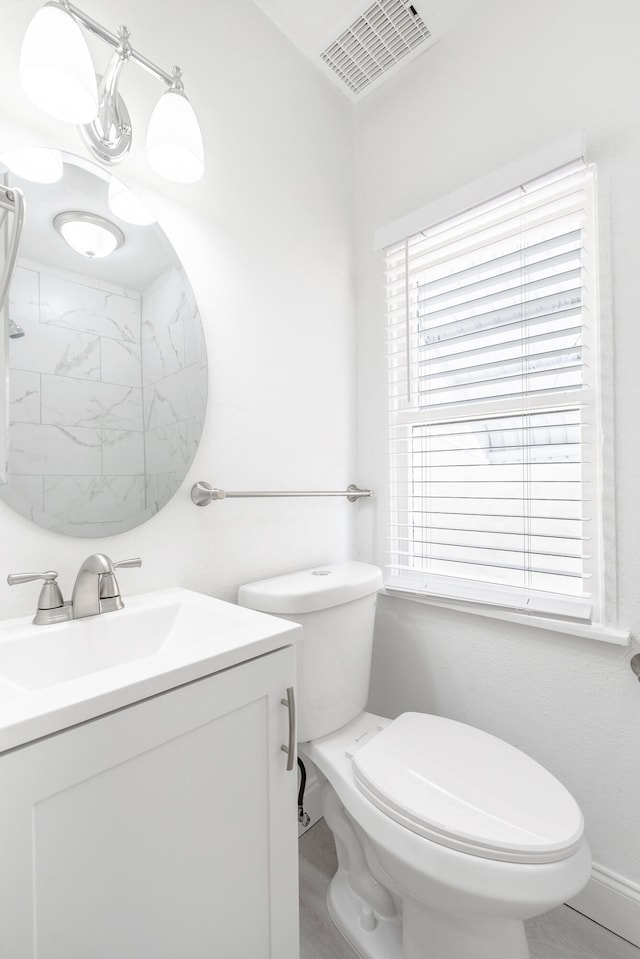 bathroom featuring vanity and toilet