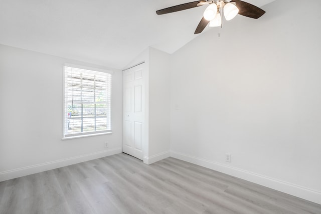 unfurnished room with lofted ceiling, light wood-type flooring, and ceiling fan