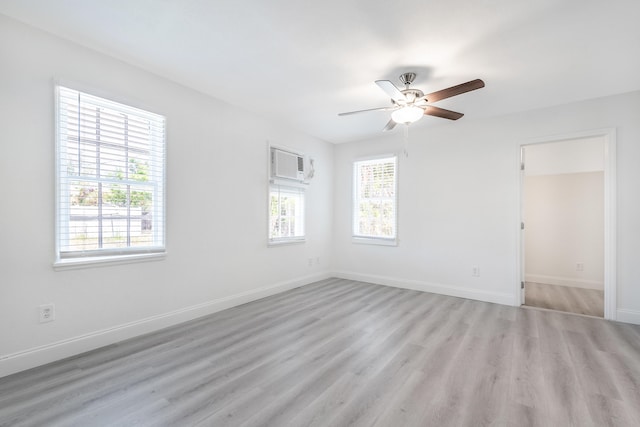 empty room featuring light hardwood / wood-style flooring, a healthy amount of sunlight, and ceiling fan