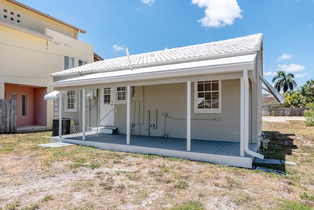 back of property featuring a wooden deck and central AC