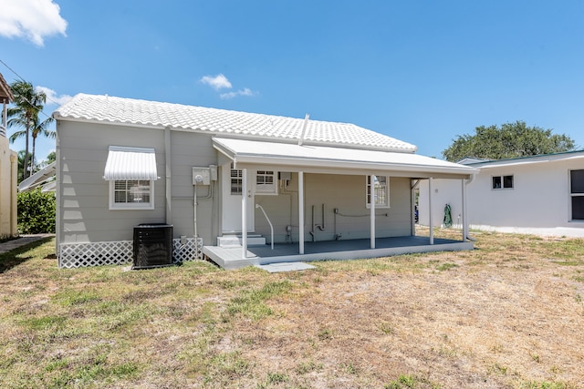 back of property featuring a patio, a lawn, and central AC unit