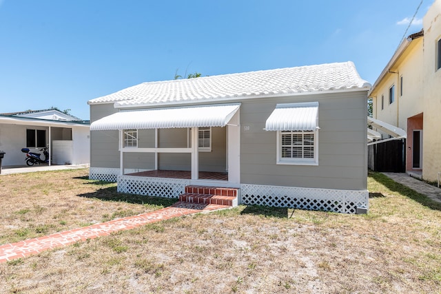 back of property featuring a lawn