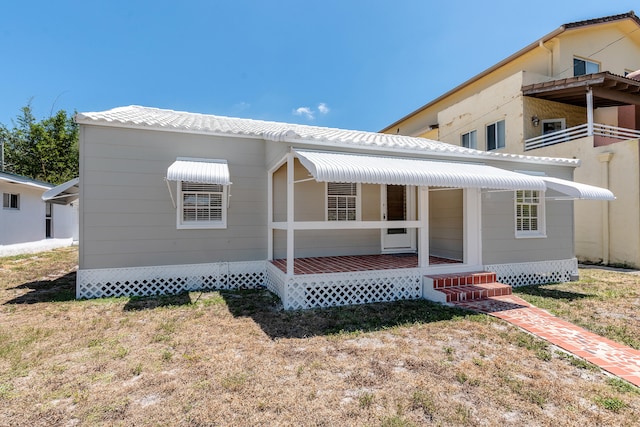 view of front of house with a balcony and a front yard