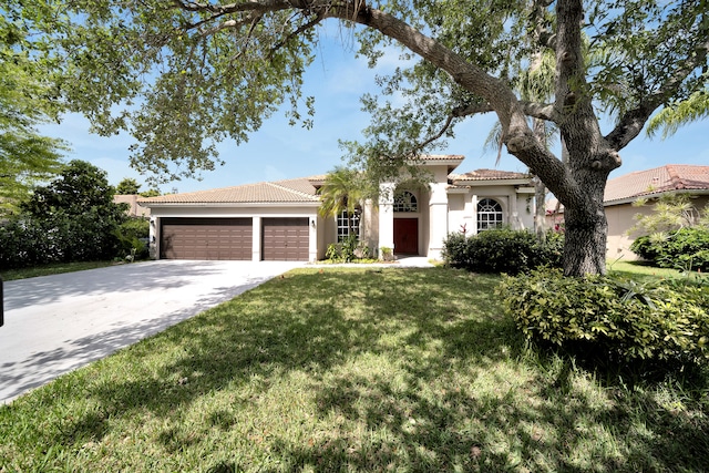 view of front of home featuring a garage and a front lawn