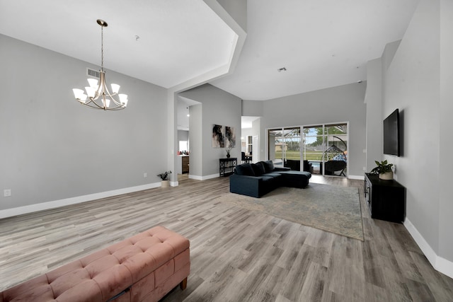 living room featuring light hardwood / wood-style floors and a chandelier