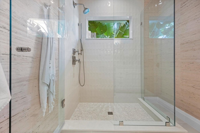 bathroom with tile walls and walk in shower