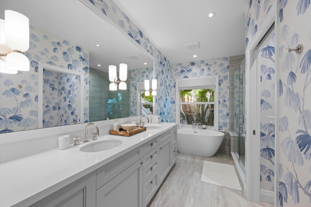 bathroom with vanity and independent shower and bath