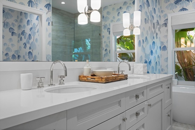 bathroom with a tub and vanity