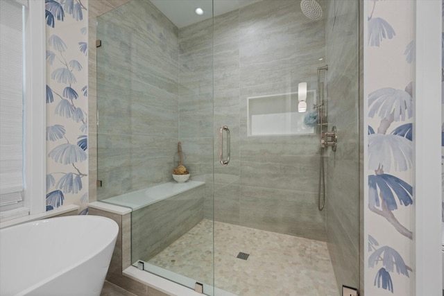 bathroom with tile walls and plus walk in shower