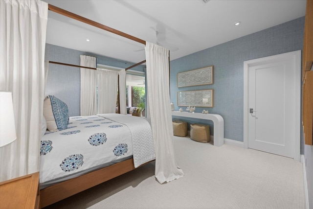 bedroom with carpet flooring and wallpapered walls