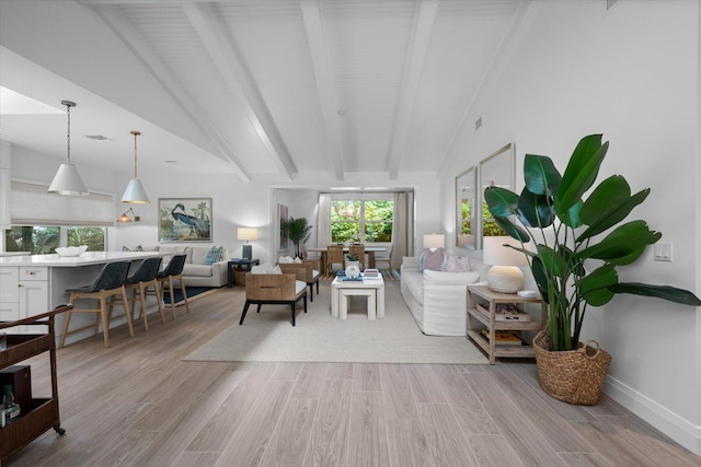 living room with light wood-type flooring and lofted ceiling with beams