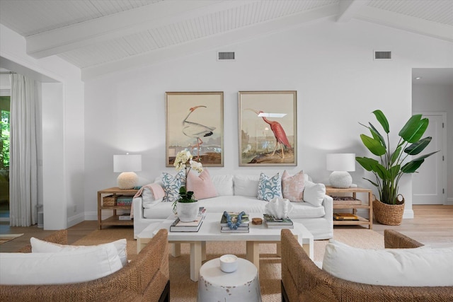 living room with light wood-type flooring and vaulted ceiling with beams